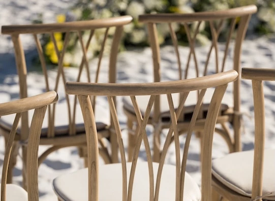 a group of chairs in the sand