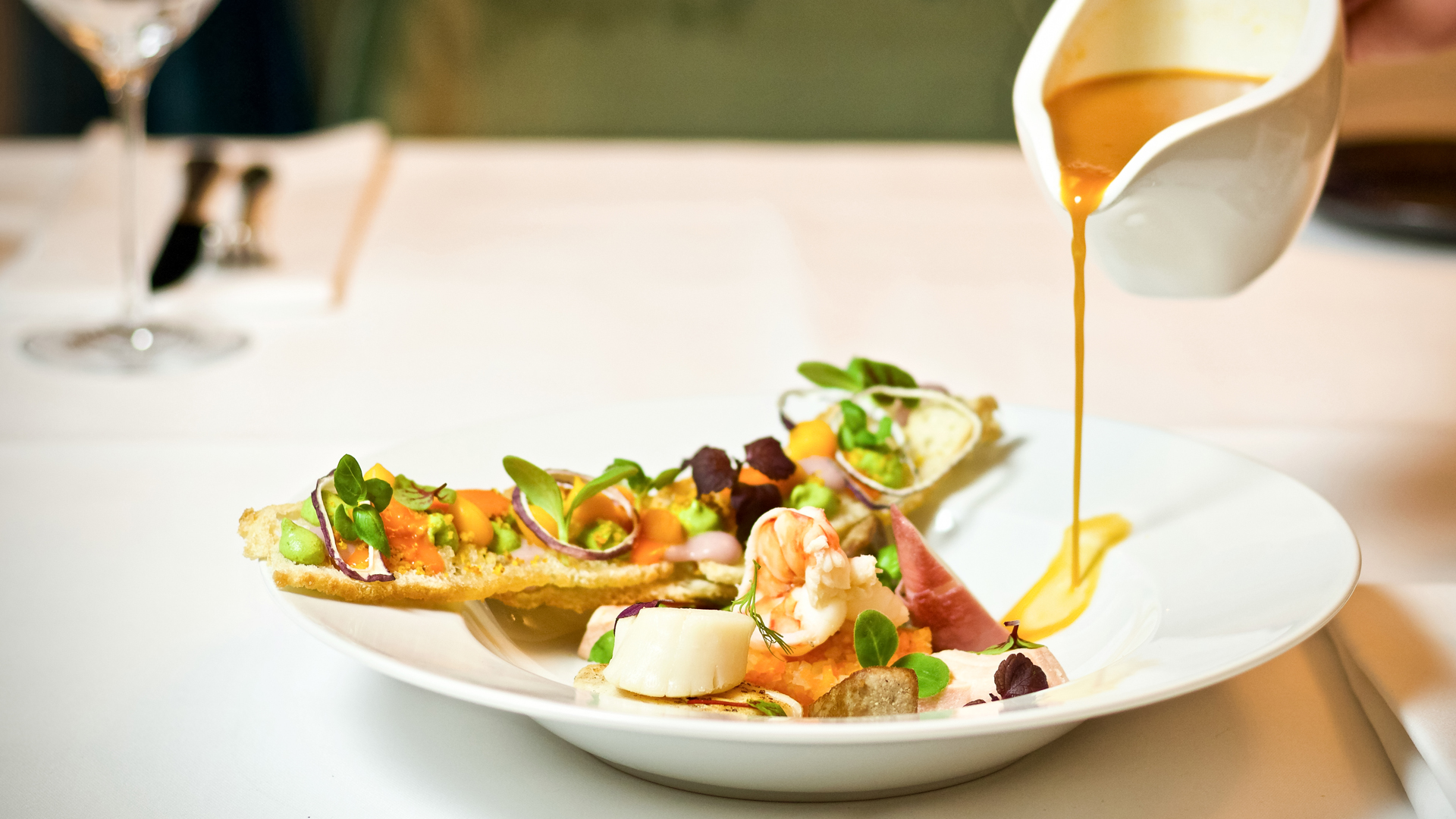 a plate of food with sauce being poured onto it