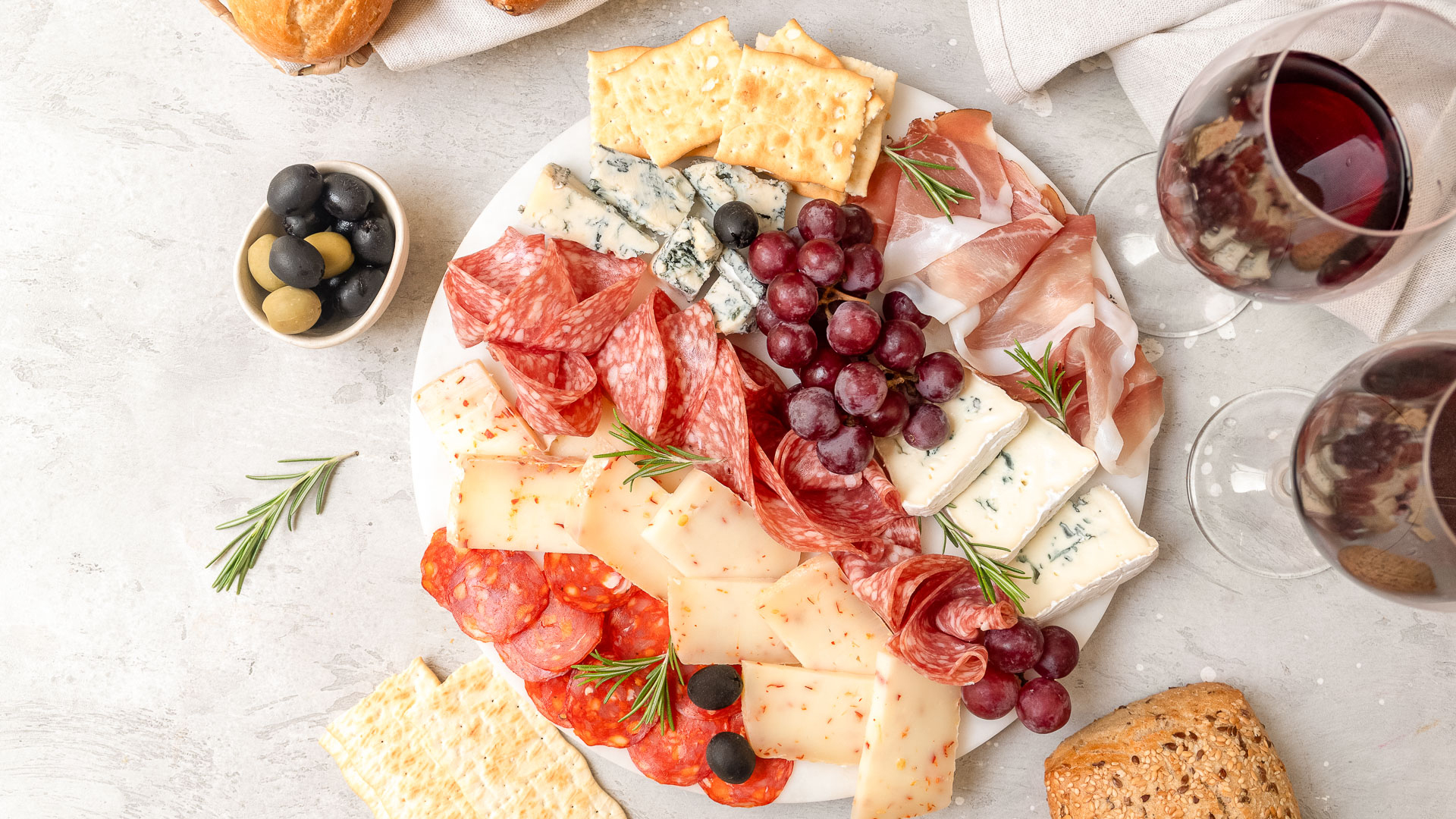 a plate of food with grapes and cheese