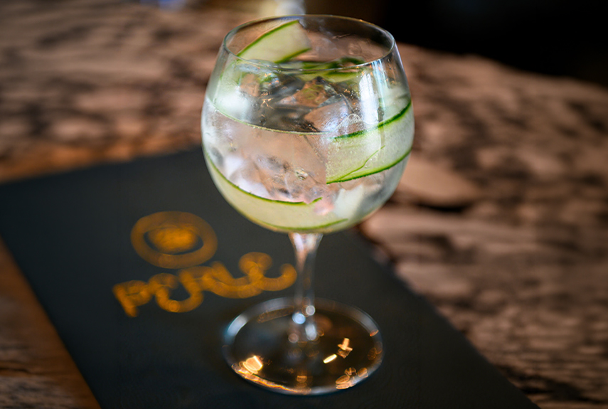 A glass of water with cucumber slices