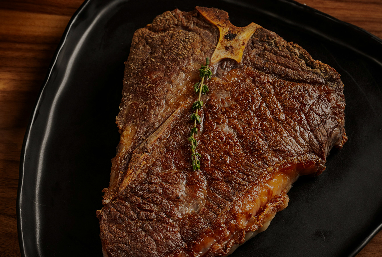 a piece of meat on a black plate