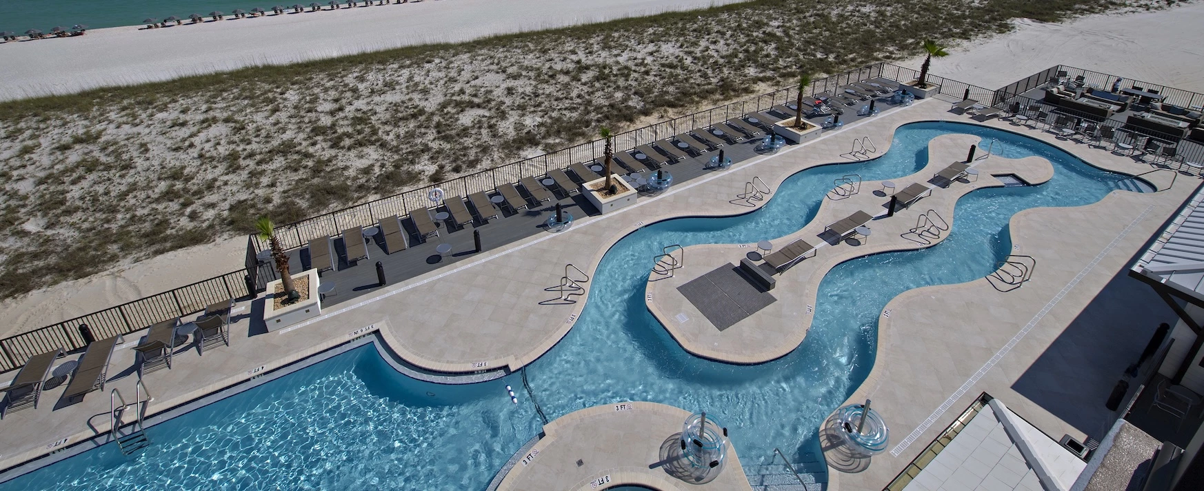 a swimming pool with chairs and a fence