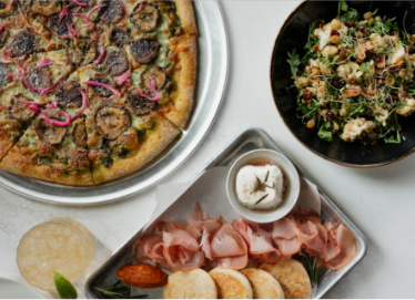 a pizza and salad on a table