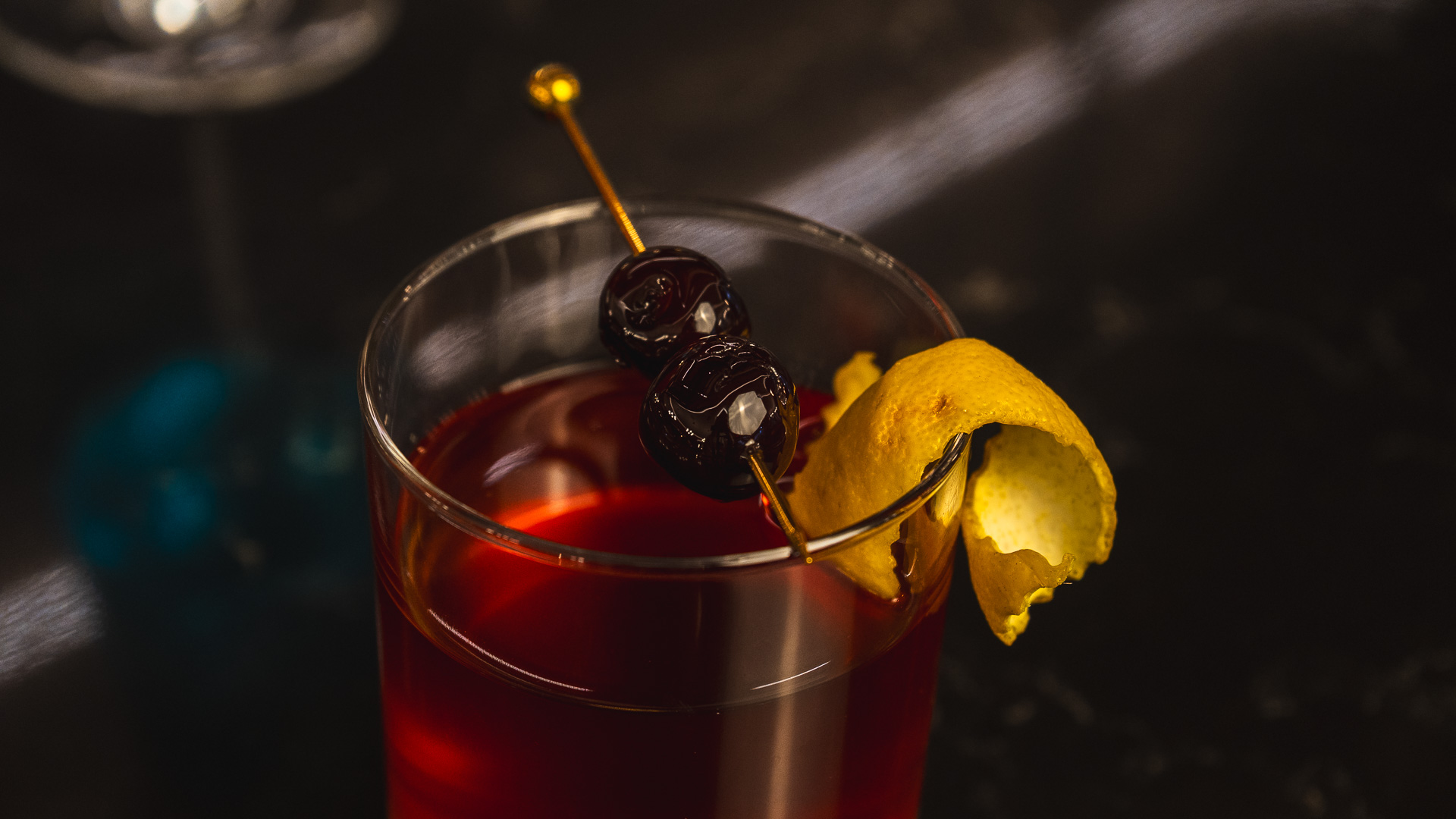 a glass with a drink and a lemon wedge