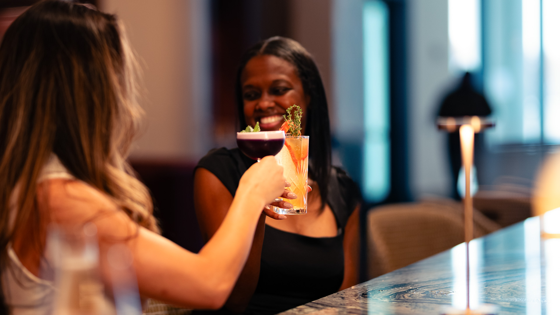 a woman holding a drink