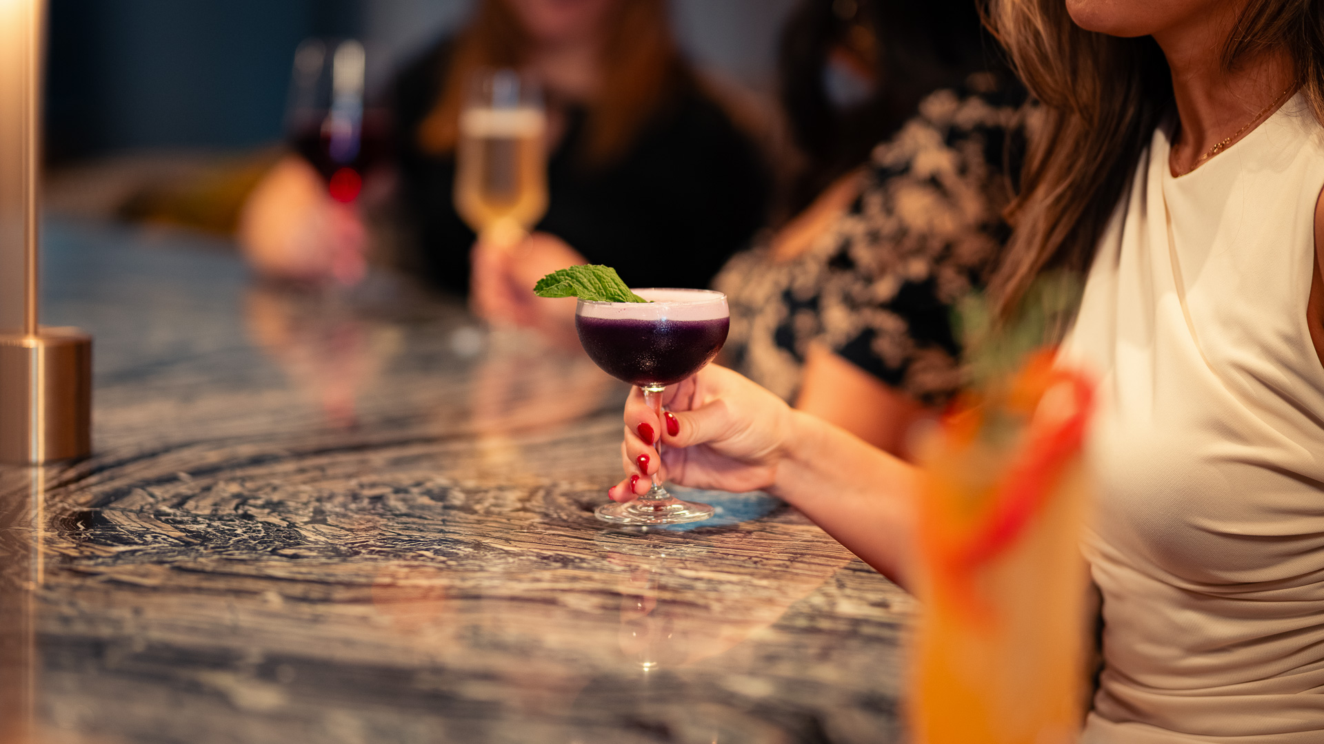 a hand holding a glass of wine