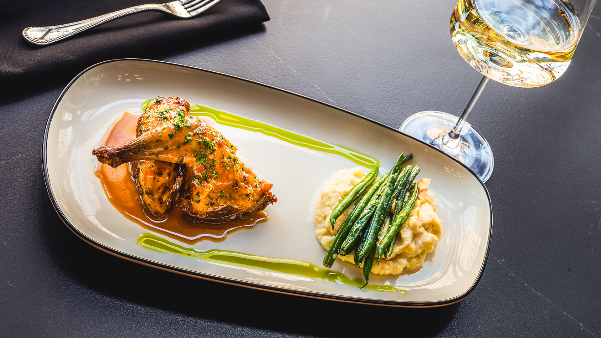 a plate of food and a glass of wine