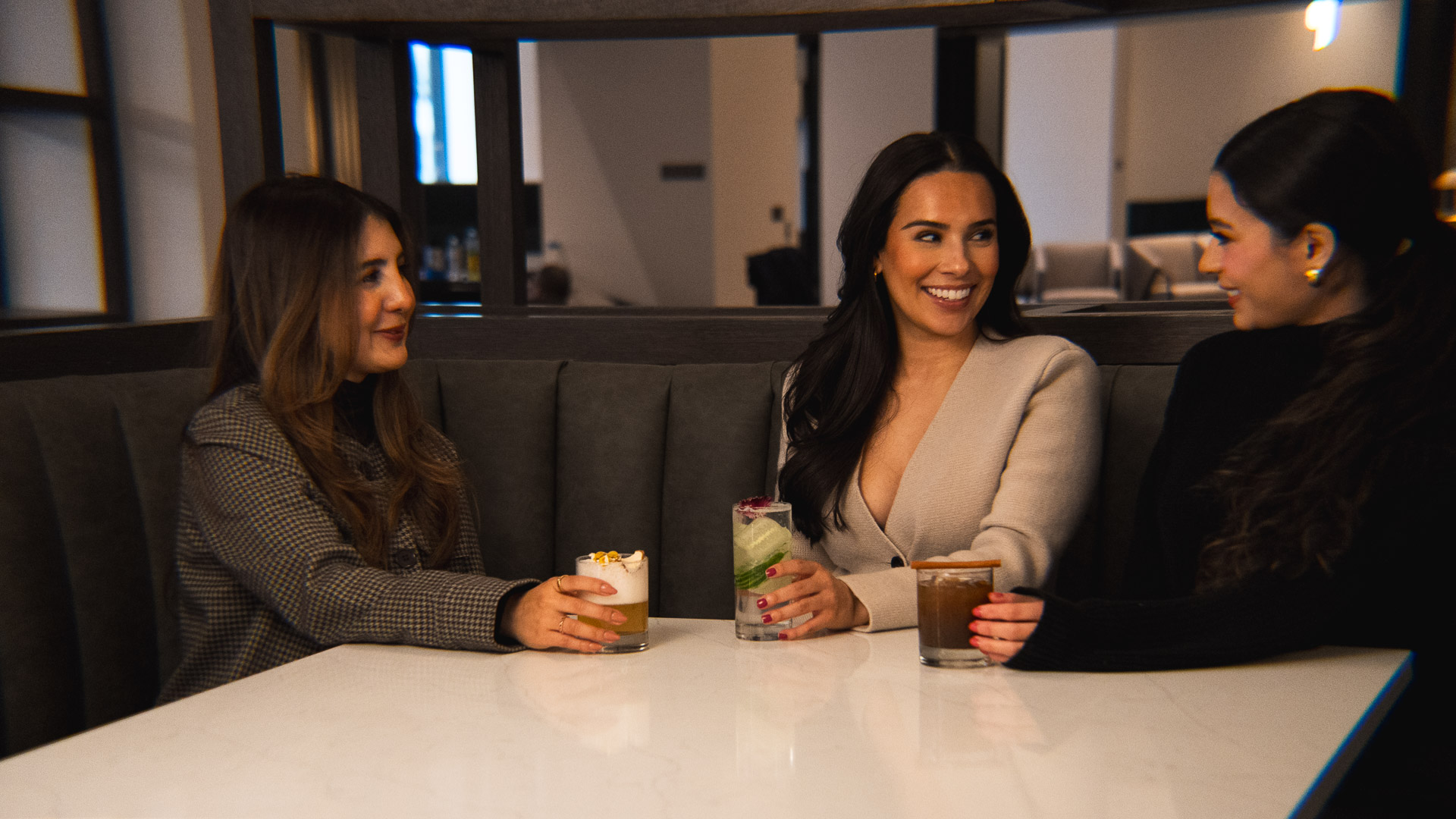 a group of women sitting at a table with drinks