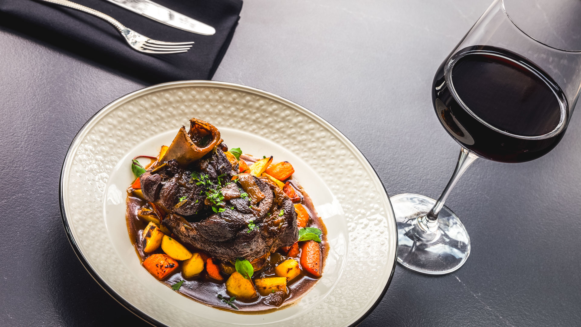 a plate of food and a glass of wine