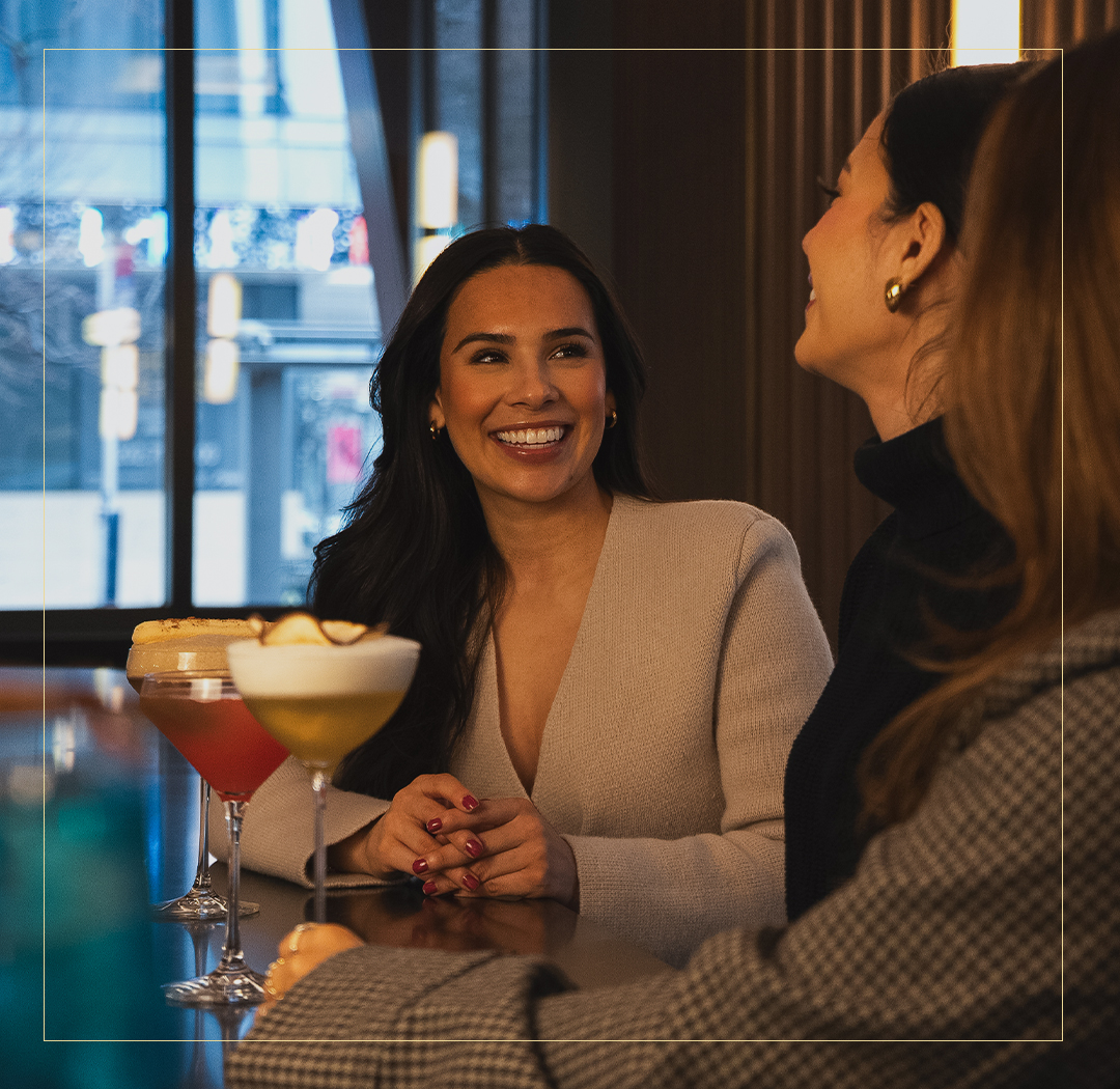 a group of women sitting at a table with drinks