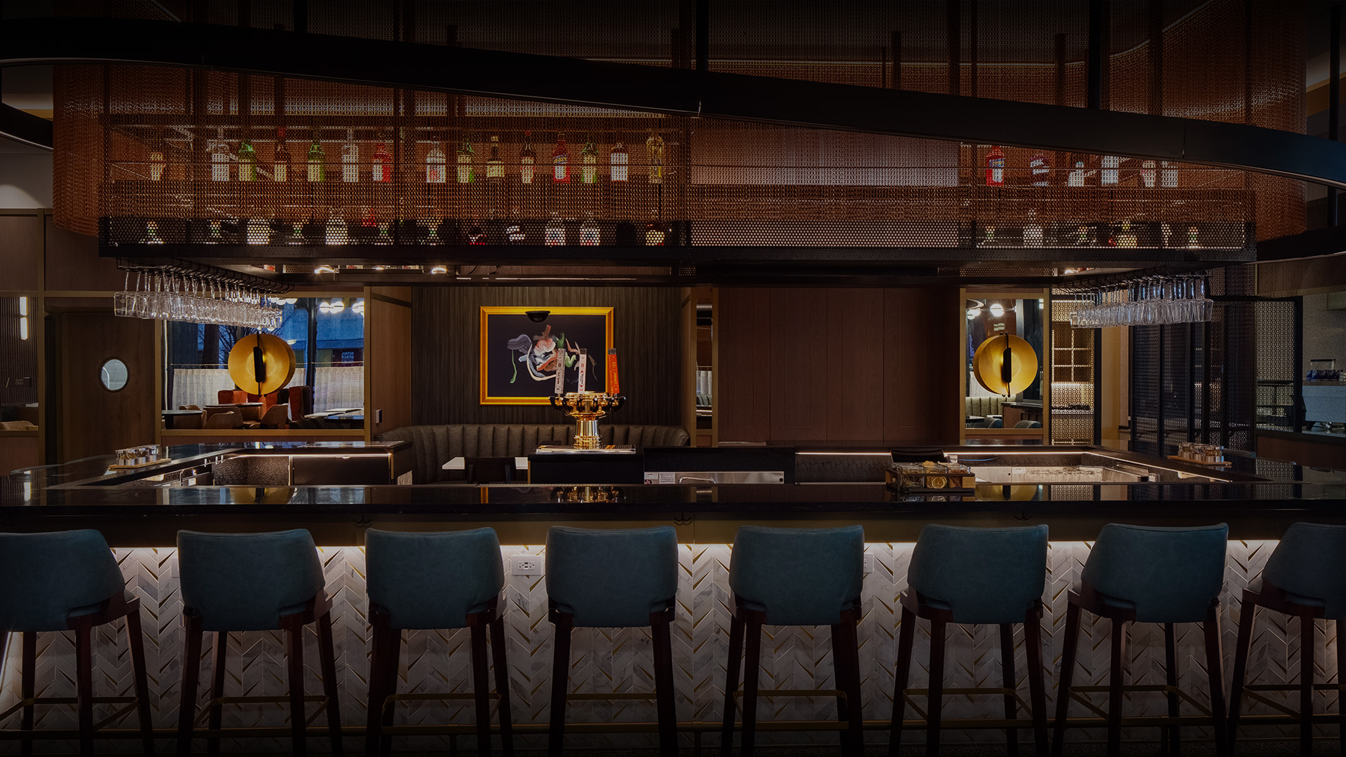 a bar with chairs and a chandelier