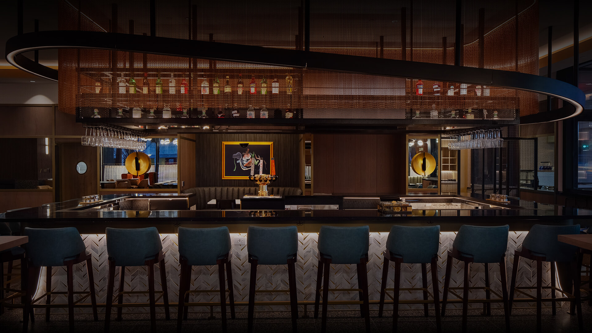 a bar with chairs and a bar
