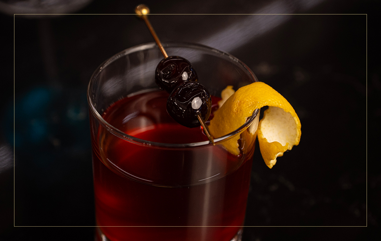 a glass with a drink and a lemon wedge