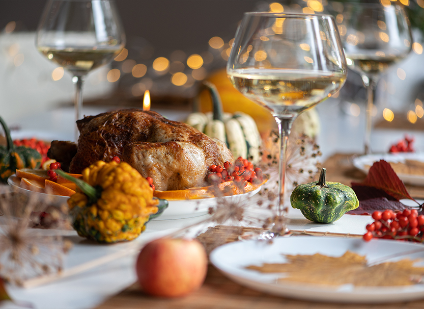a table with food and wine glasses