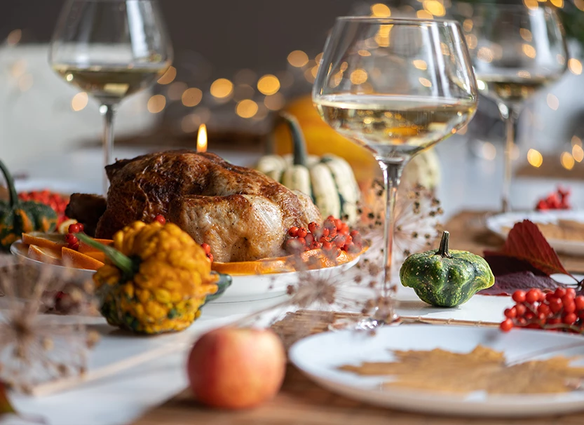 a table with food and wine glasses