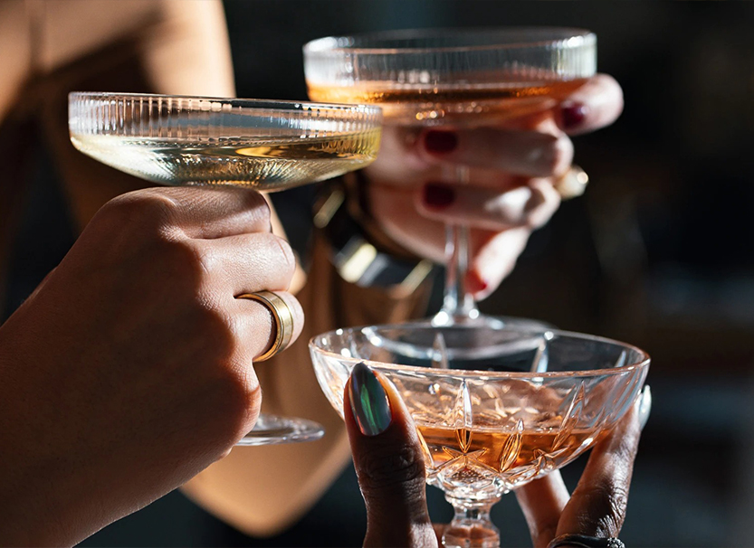 a group of hands holding glasses