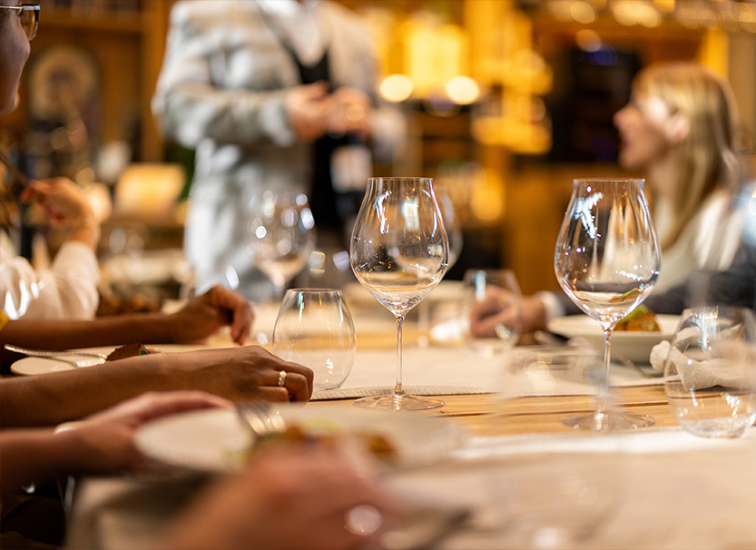 a group of people sitting at a table with wine glasses