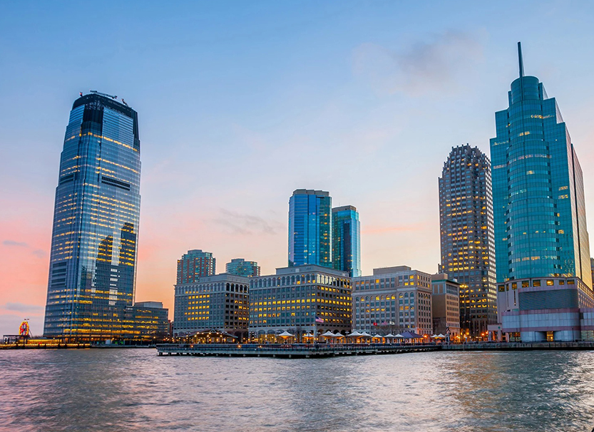 a city skyline with many tall buildings and a body of water