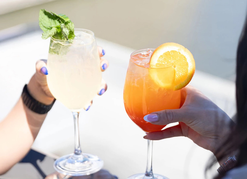 a pair of hands holding drinks