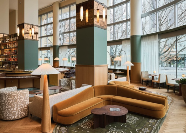 a room with a large column and couches