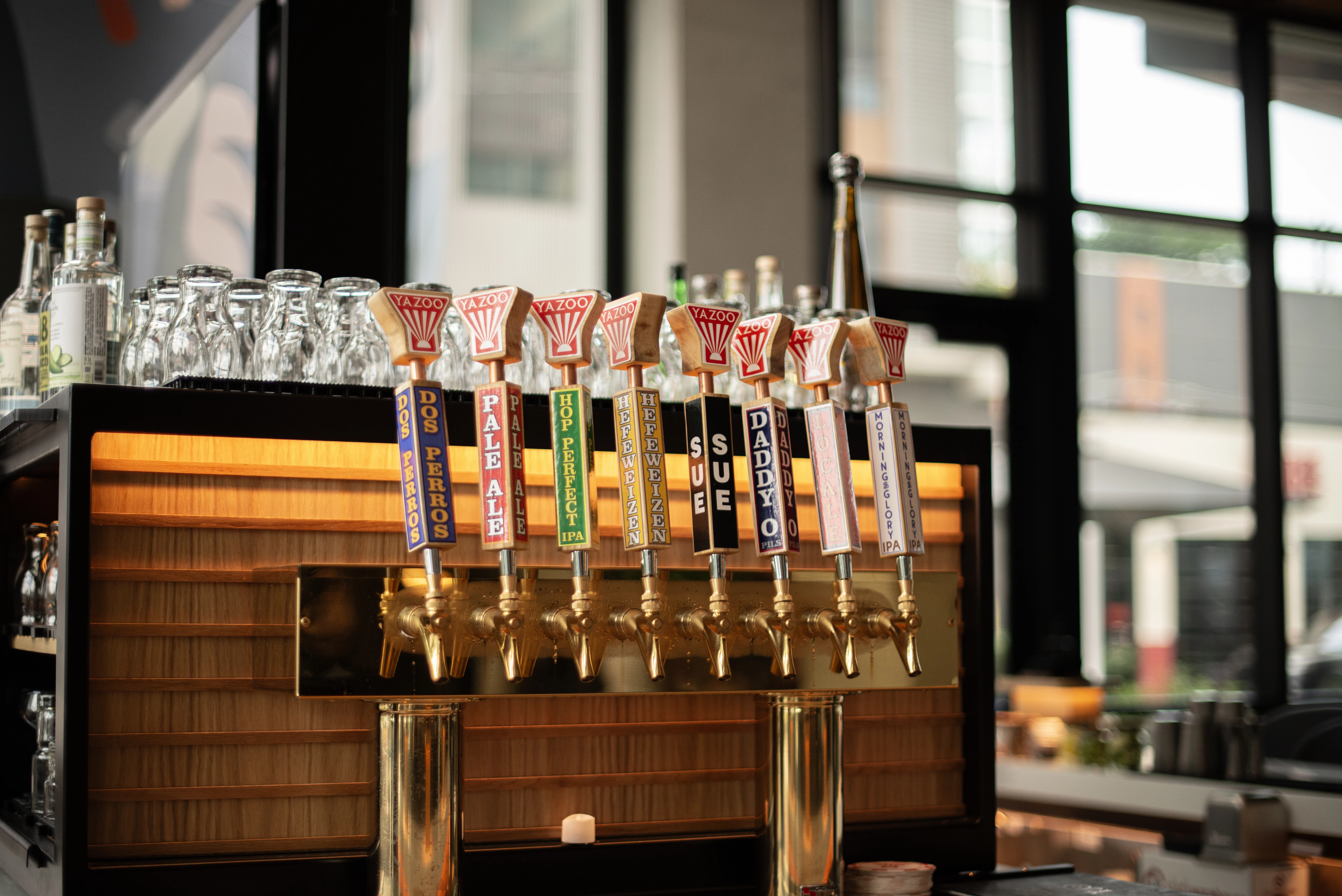 a row of beer taps on a bar