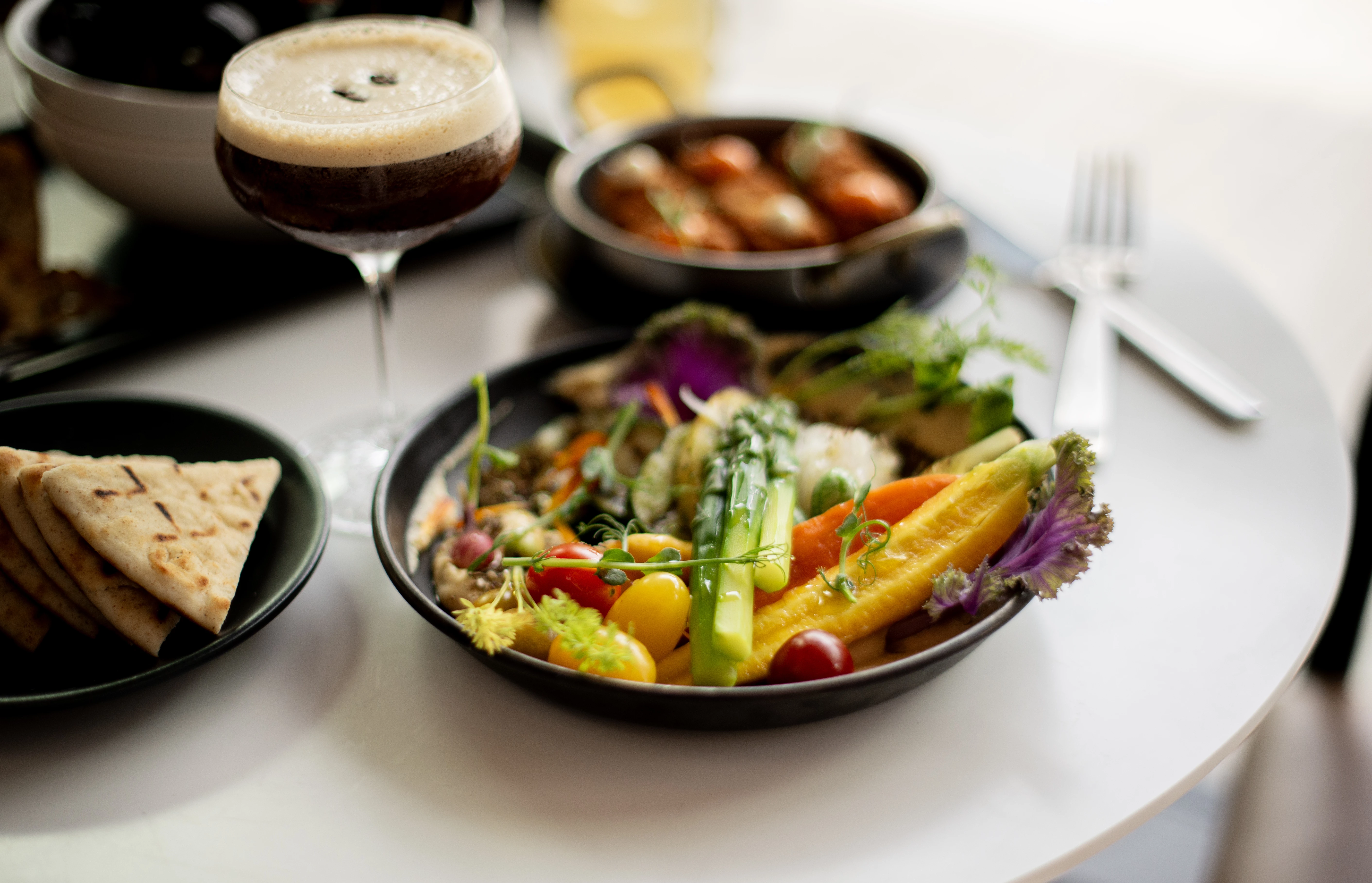 a plate of food and a glass of beer
