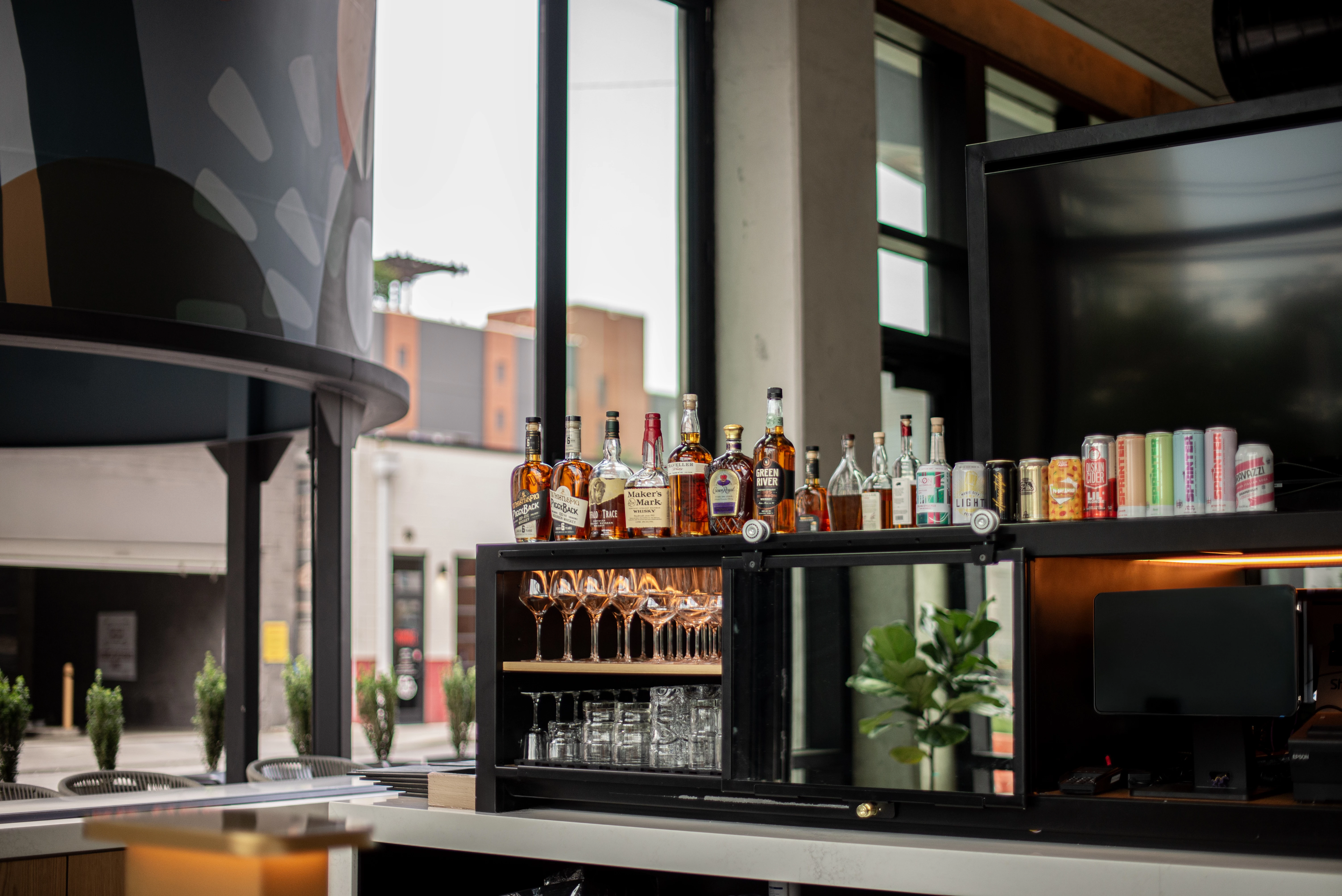 a shelf with bottles and glasses on it
