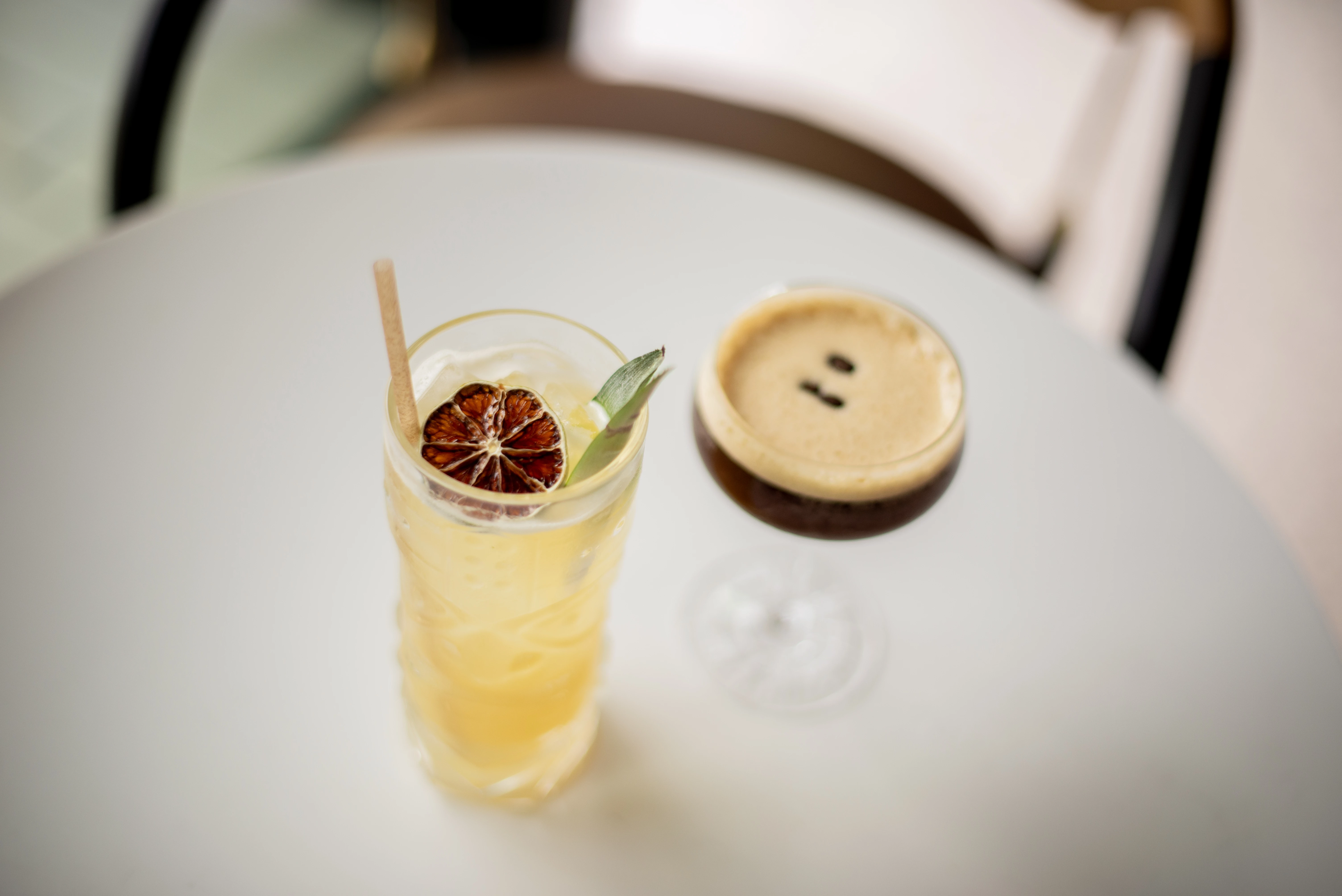 a glass of liquid next to a drink