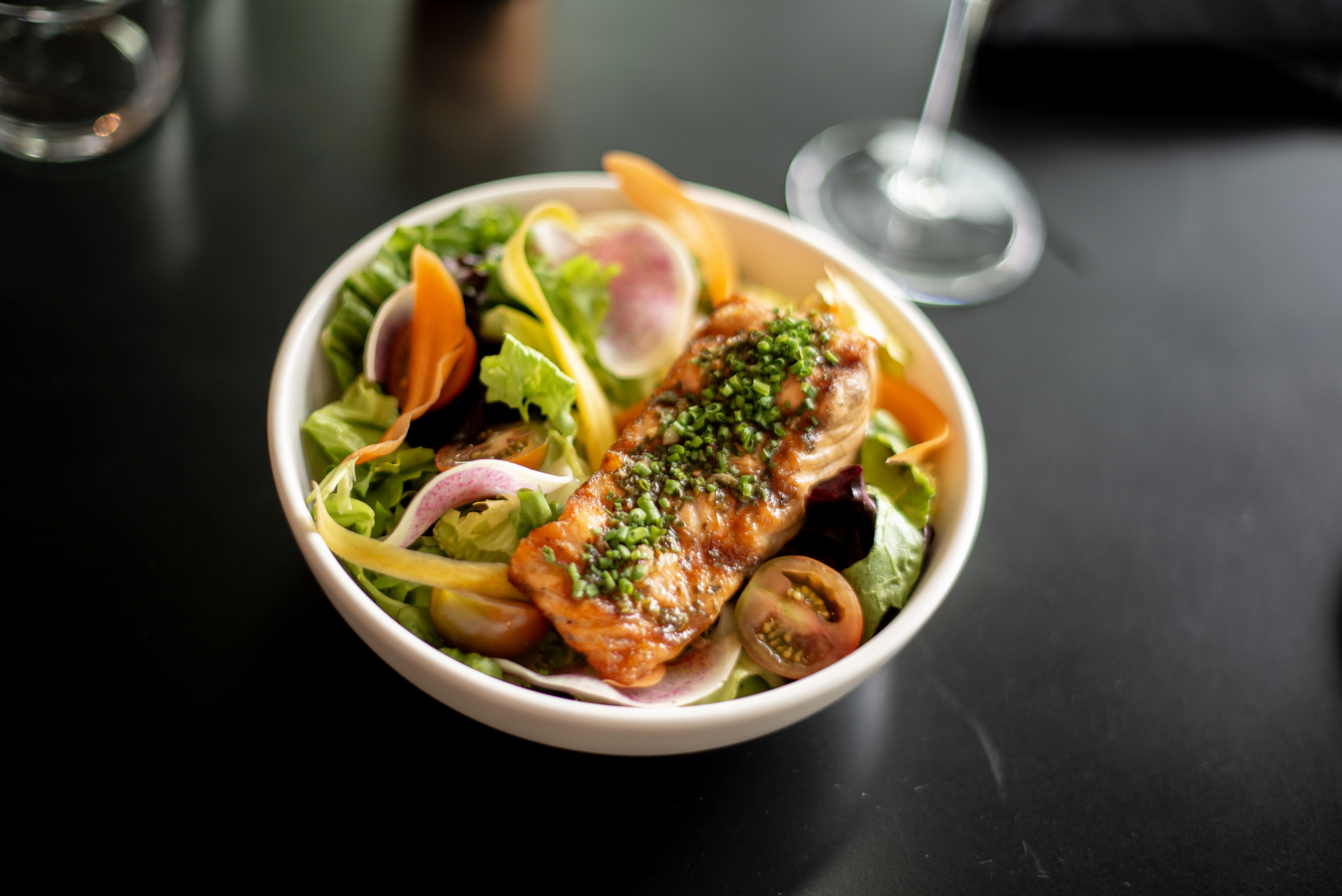 a bowl of salad with meat and vegetables