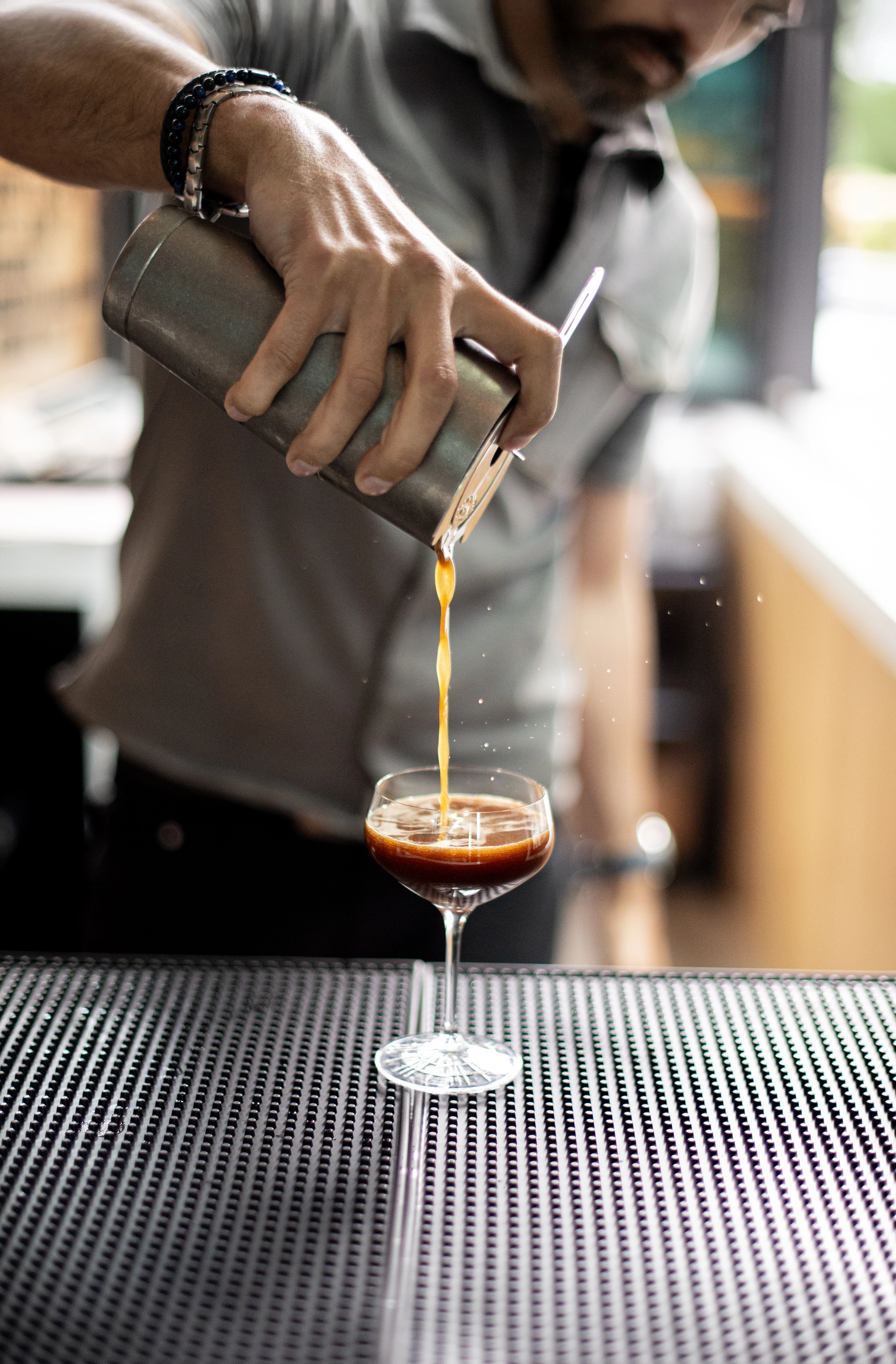 a person pouring liquid into a glass