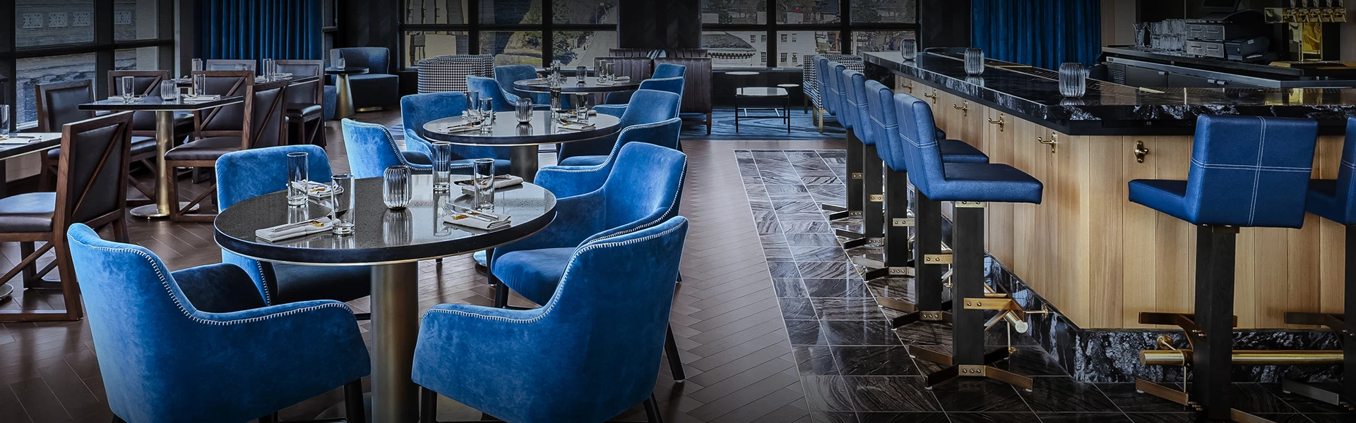 a restaurant with blue chairs and tables