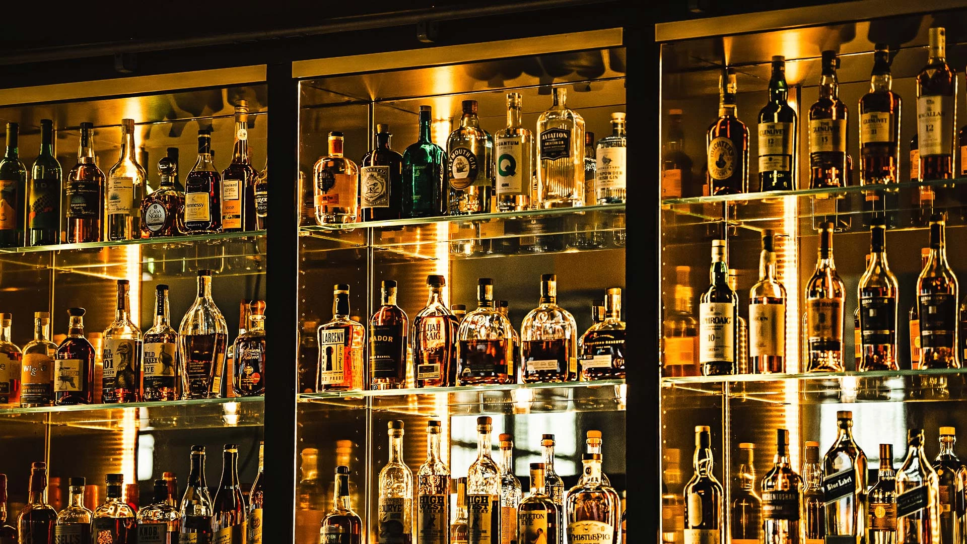 a shelf with bottles of alcohol