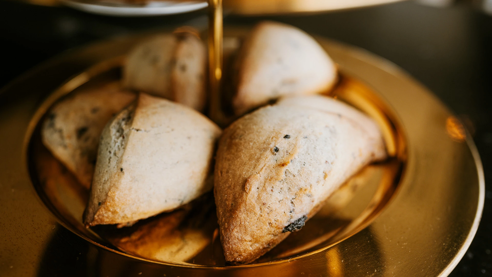 a group of pastries on a gold plate