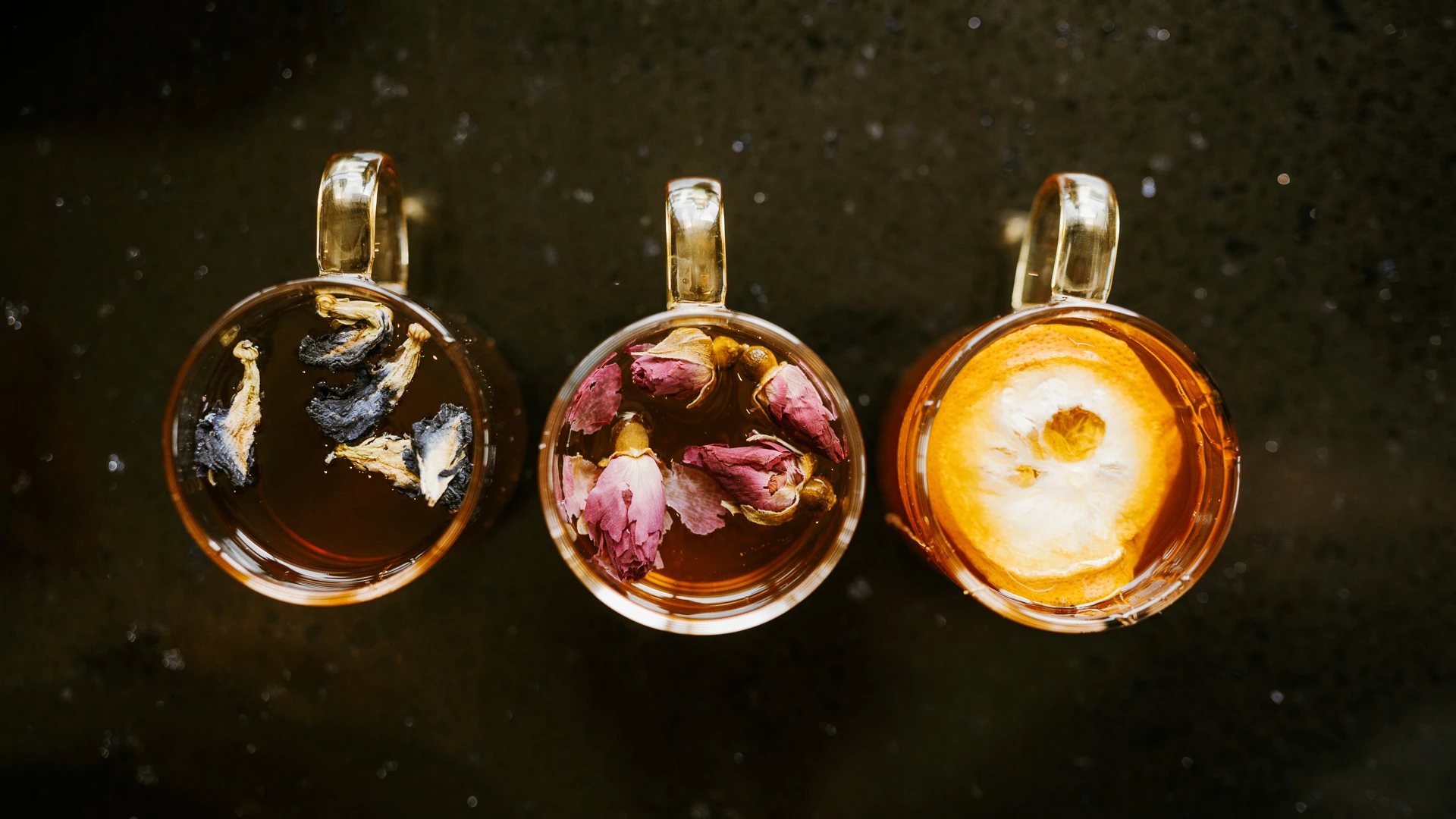 a group of mugs with different colored liquid