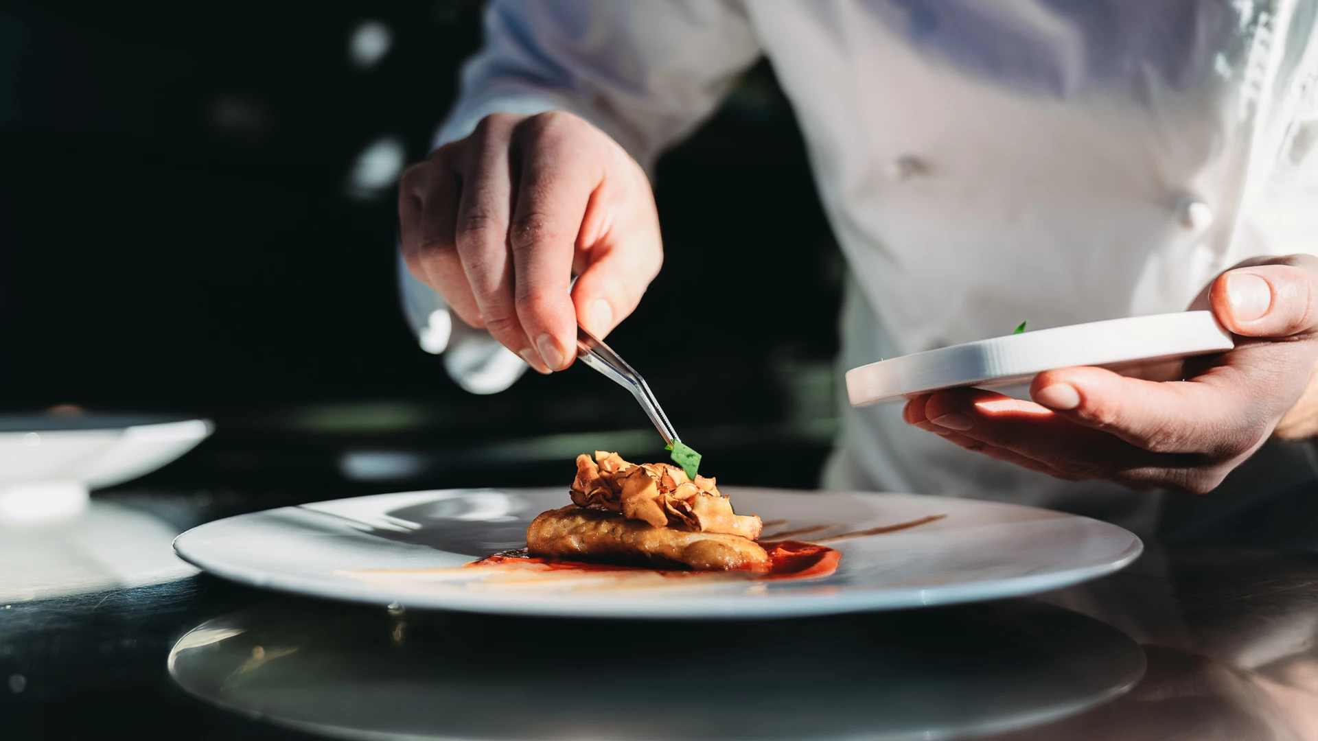 a person holding a fork over a plate of food