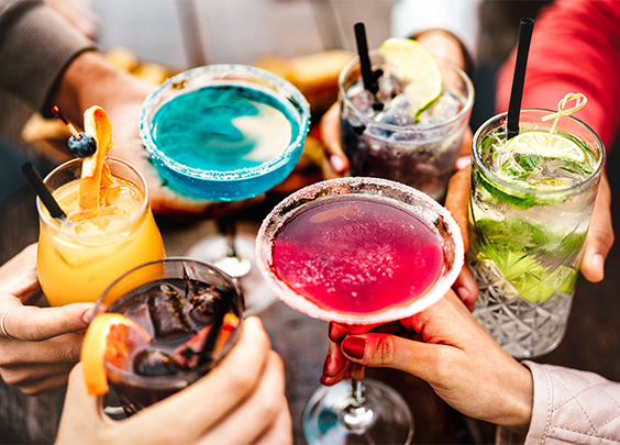 a group of hands holding drinks