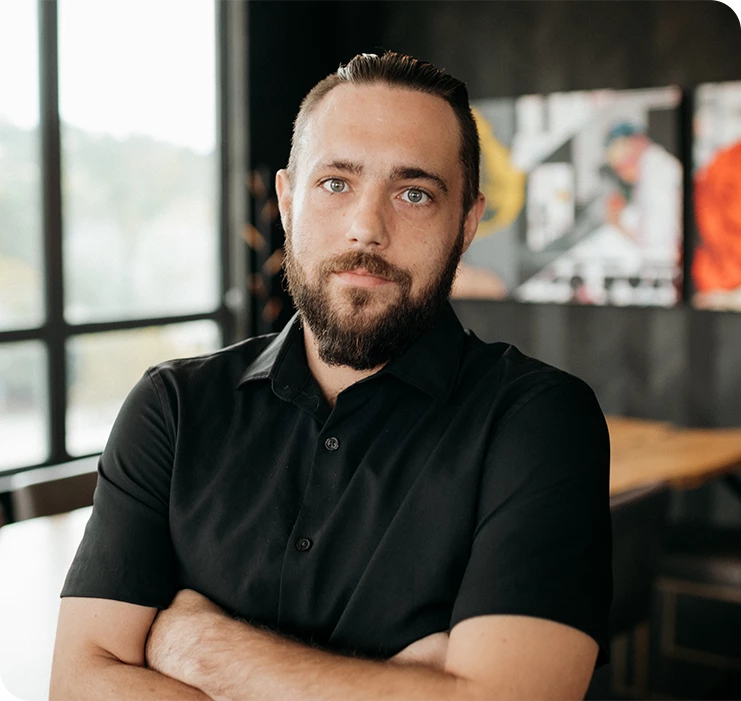 a man with a beard and folded arms