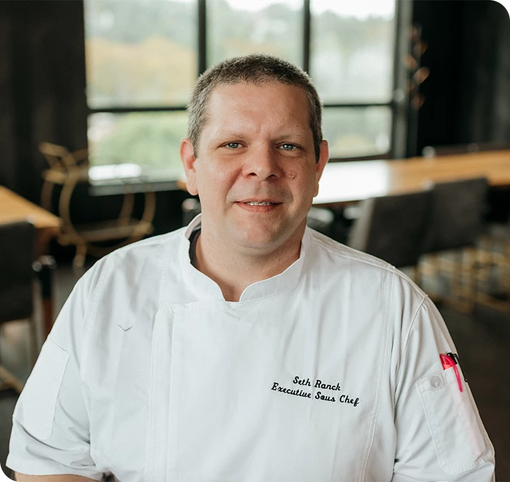 a man in a white chef's coat