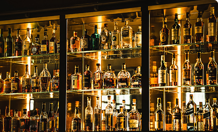 a shelf of liquor bottles
