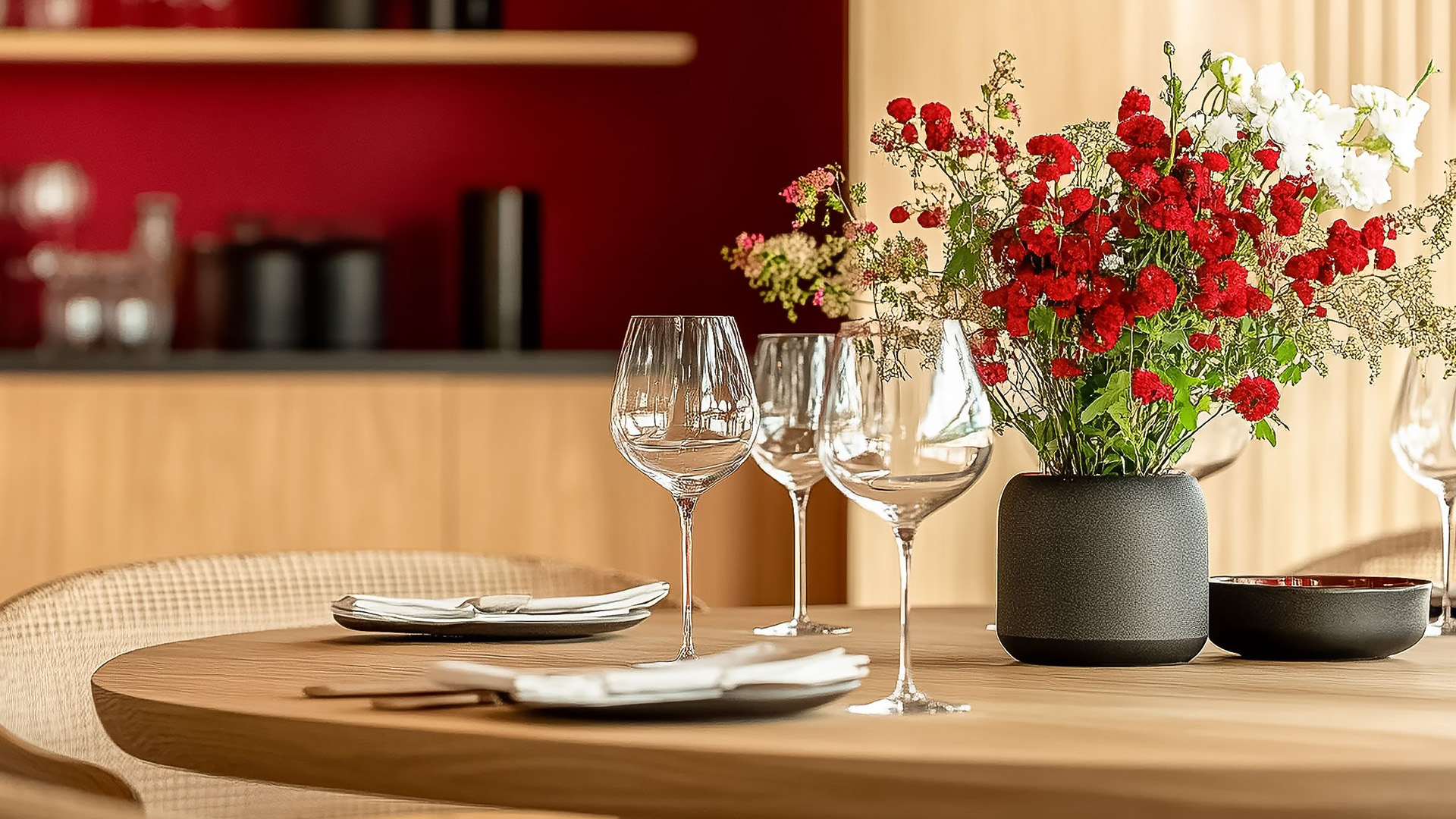 a table with wine glasses and flowers