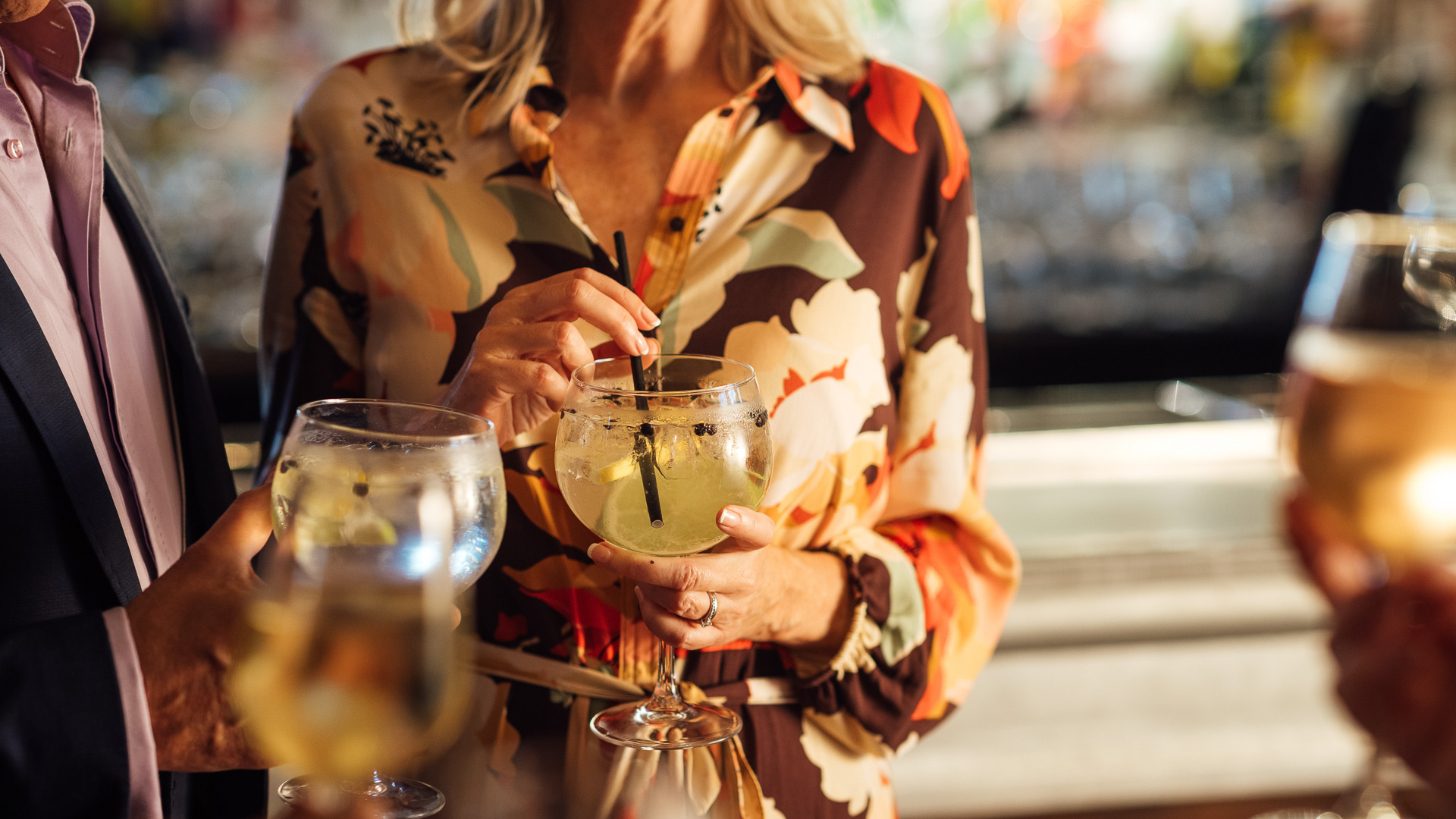 a woman holding a drink with a straw