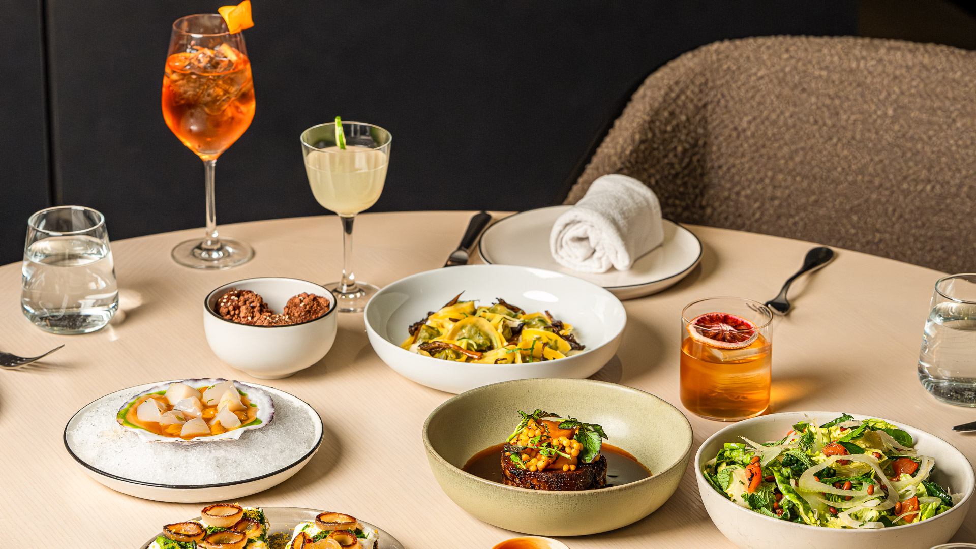 a table with plates of food and drinks
