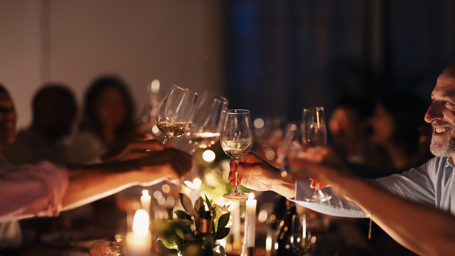 a group of people holding wine glasses