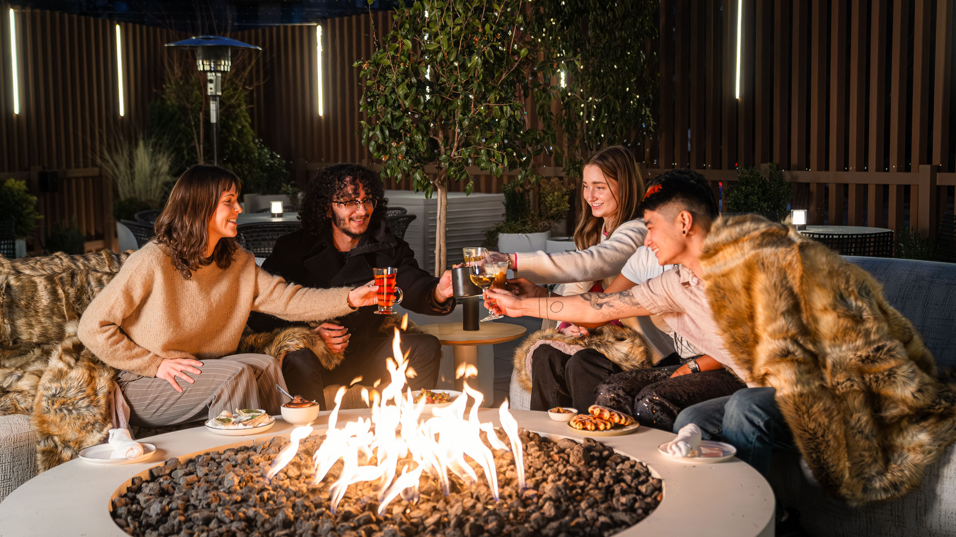 a group of people sitting around a fire pit