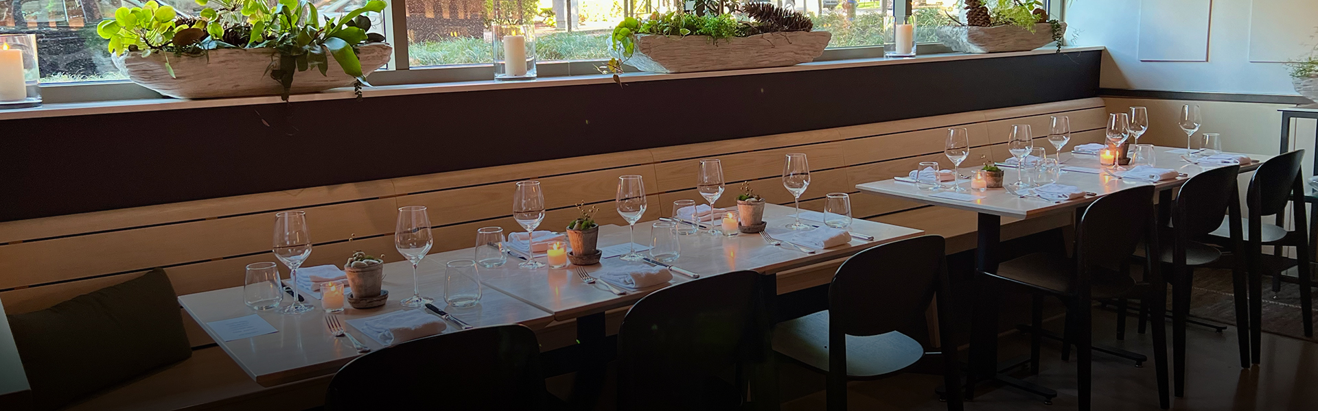 a table with wine glasses and candles