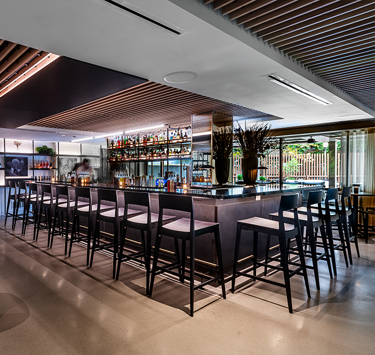 a bar with chairs and a counter