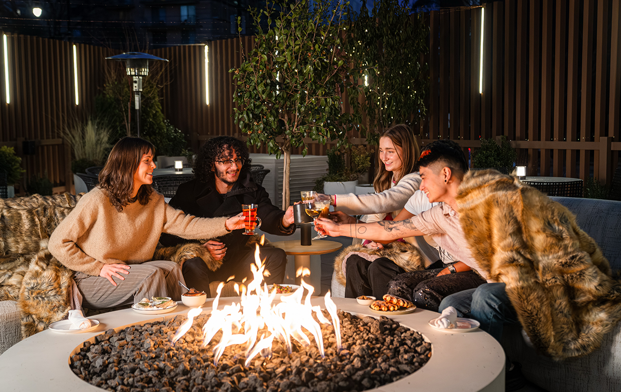 a group of people sitting around a fire pit