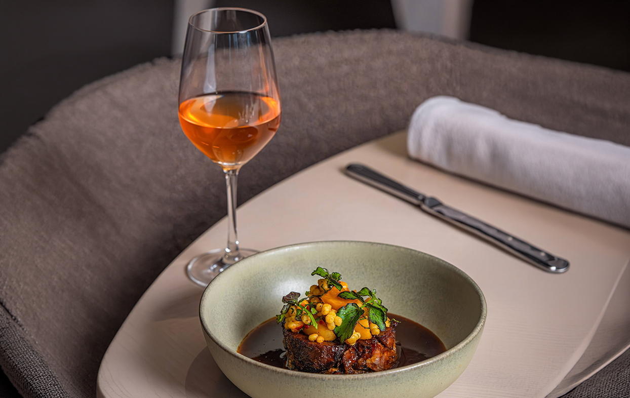 a plate of food and a glass of wine