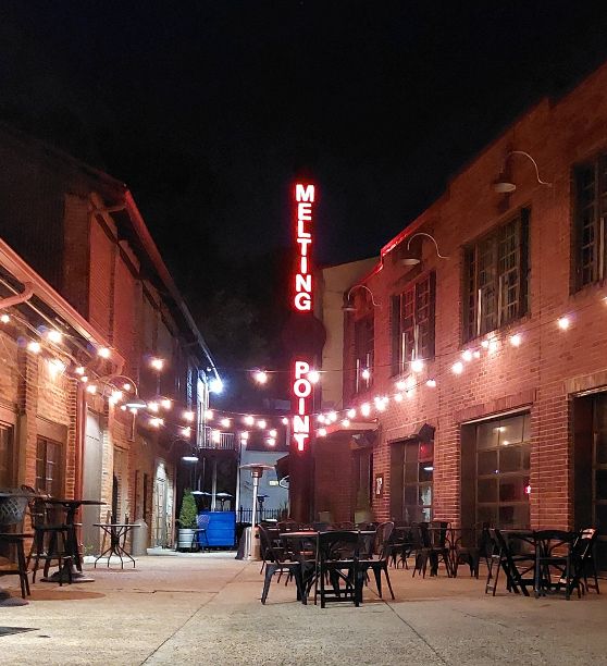 a brick building with tables and chairs