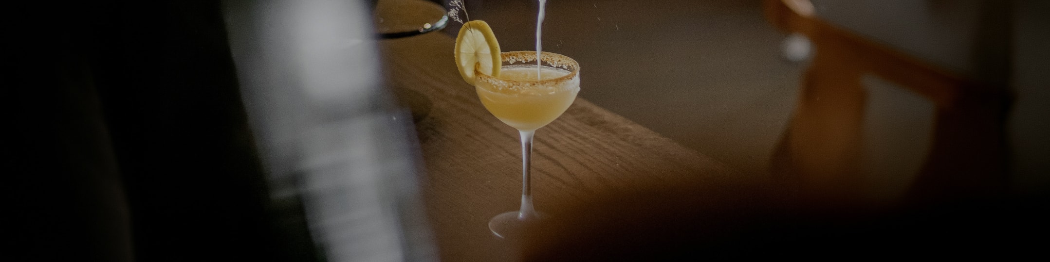 a glass with a drink and a lemon slice on top